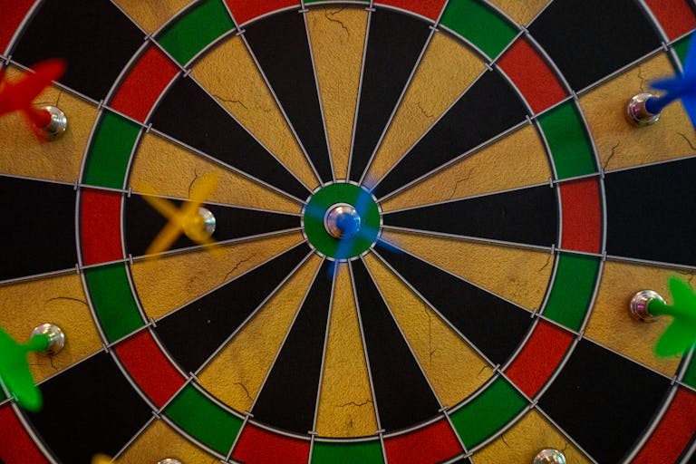 Close-up of a vibrant dartboard with darts highlighting accuracy and precision.